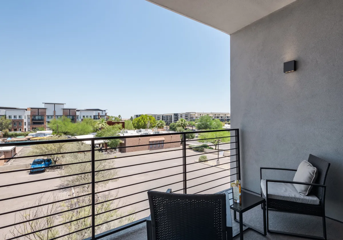 This image features balcony chairs and railings with a street view below, ideal for relaxing or people-watching. The scene conveys the serene aspect of Thunderbird’s exterior amenities and how groups or families can come together for a morning coffee or evening chat outdoors.