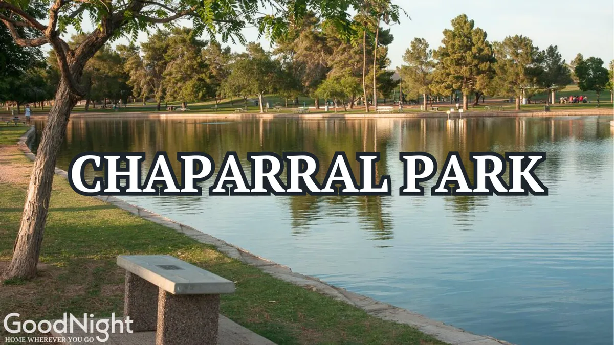 A tranquil scene of a lake surrounded by trees and a park bench, suggesting a peaceful outdoor space perfect for walking dogs or relaxing in nature. The water reflects the sunset, and the area is ideal for morning jogs or picnics.